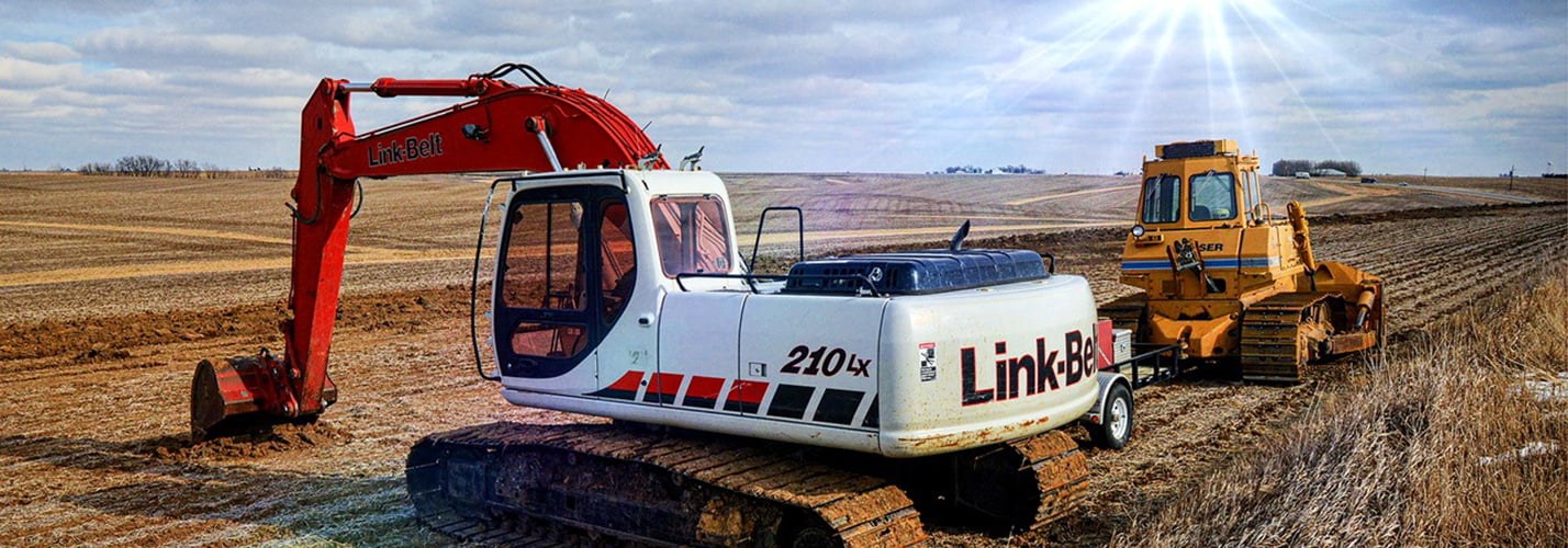 Link-Belt 210LX excavator and a wheeled dozer working an open Iowa field