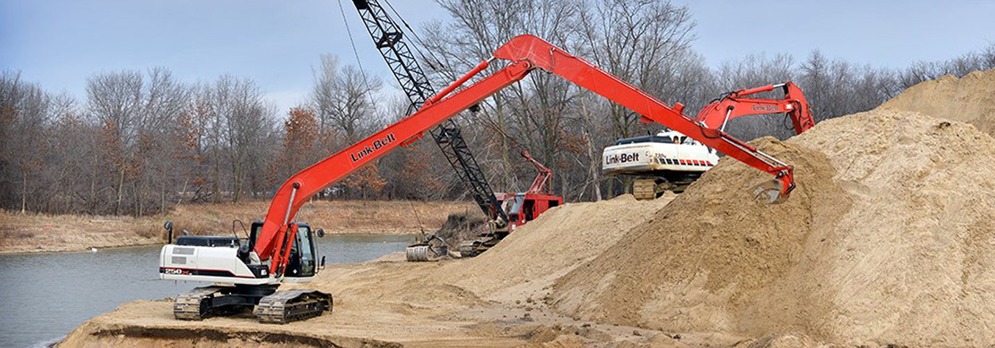 Link-Belt long-reach excavator working a sand pit beside a dragline crane