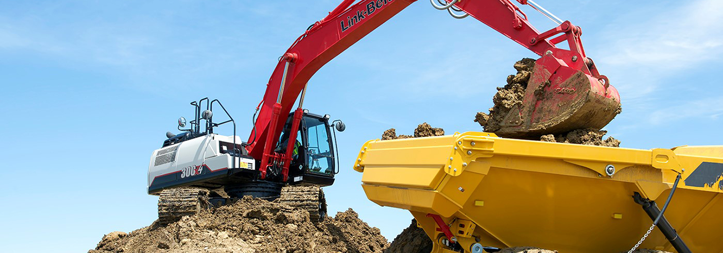 Link-Belt excavator loading soil into a scraper pan on a dirt-moving job